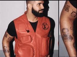 Hugely popular with illicit fans everywhere her art will make any product stand out from the crowd. Rapper Drake Tattoos Photo Of His Son Adonis On His Arm Gist Gossip