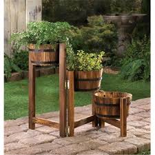 This rustic rain barrel reservoir stands on an antique metal base and will serve long as a rainwater collector. Zingz Thingz 57070003 Staggered Rain Barrel Planter Stand Walmart Canada