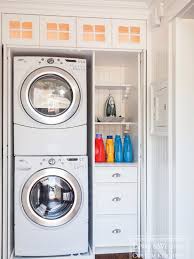 Lewis And Weldon Hidden Laundry Closet With Stackable Front Loading Washer And Dryer And Built In Storage Laundry Closet Hidden Laundry Laundry Room Makeover
