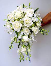 With a mix of dried wildflowers and preserved rose heads, this arrangement is timeless! All White Cascade Bouquet With Roses And Dendrobium Orchids Small Wedding Bouquets Flower Bouquet Wedding Cascading Wedding Bouquets