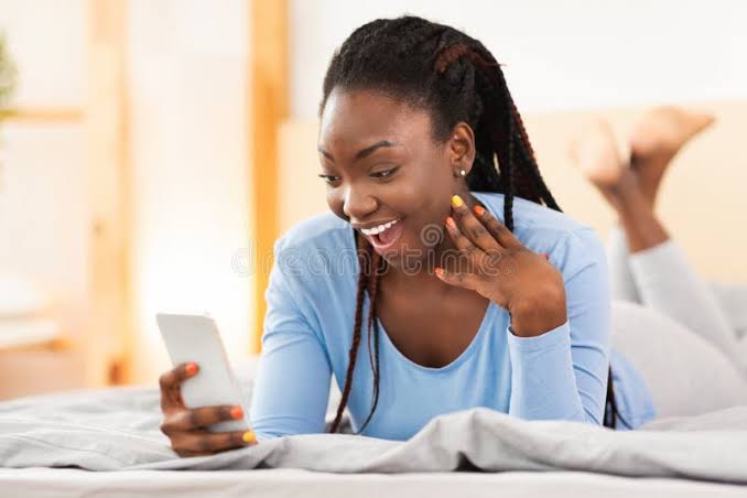 Excited Black Girl Reading Message on Smartphone Lying in Bed Stock Image - Image of bedroom, mobile: 168635313