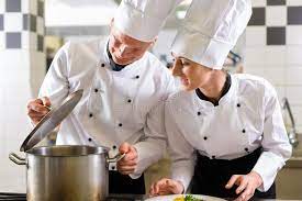 Two Chefs In Team In Hotel Or Restaurant Kitchen Two Chefs Man And Woman In Affiliate Hotel Restaurant Restaurant Kitchen Recipe Images Restaurant