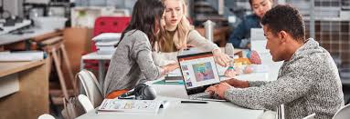 Office 365 For Free For Students Four Students Sitting At A Table Outside Using Office 365 Education On Tab Student Office 365 Education Office 365
