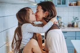 Mom kisses her little daughter in the kitchen 11467086 Stock Photo at  Vecteezy