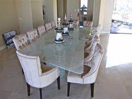 There's a modern fireplace across it that's fixed to the stone brick wall. Celebrate The New Year With Fab Glass Tables Sans Soucie Glass Dining Room Table Glass Dining Table Glass Table