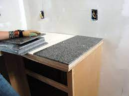 Use a knife and a metal ruler to cut the shell and glue the tiles into strips that correspond to the height of the edge of the countertop. How To Install A Granite Tile Kitchen Countertop How Tos Diy