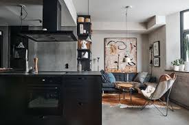 An industrial living room with retro touches, a metal floor lamp, leather furniture and concrete walls and floor. Raum Room Interior Design Inspiration