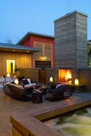Plastering a brick chimney to look modern with a sand finish. Sizzling Style How To Decorate A Stylish Outdoor Hangout With A Fireplace