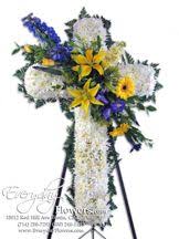 Wow with the perfect bouquet! 160 White Funeral Cross With Blue Denphiniumn And Yellow Tiger Lilies Funeral Flower Arrangements Funeral Floral Arrangements Funeral Floral