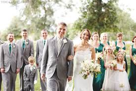 A Delighted Wedding Party Of Groomsmen In Grey Suits And Bridesmaids In Emerald Green Gowns H Green Wedding Dresses Green Themed Wedding Emerald Green Weddings