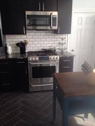 Black Cabinets Marinace Black Granite White Subway Tile With Black Grout Black Herri Kitchen Remodel Small White Kitchen Decor White Tile Kitchen Backsplash