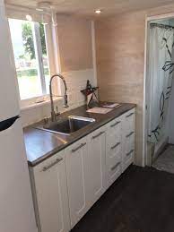 It can be opened up for cooking, then closed off when guests arrive. Using Ikea Cabinets In A Tiny House An In Depth Review Tiny Modern Homes