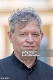 US director Jay Scheib stands in front of a bust of Richard Wagner.... News  Photo
