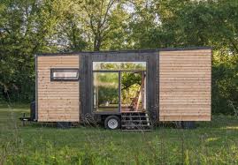 The kitchen's wood surfaces include a bamboo counter, red cedar shelves, and a white pine ceiling. Alpha A Luxurious Tiny House By New Frontier Tiny Homes
