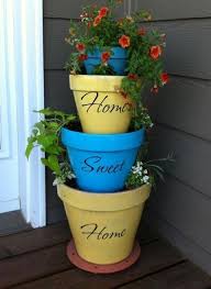 24 Seriously Creative Ways To Spruce Up A Plain Old Flower Pot Stacked Flower Pots Garden Projects Painted Terra Cotta Pots