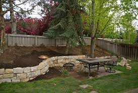 This example shows how the stone used can be arranged in such a way that it tricks the eye and makes the sloped backyard less obvious than it would be without the wall in place. Our Backyard Sloped Backyard Backyard Landscaping Designs Sloped Backyard Landscaping