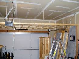 How about creating a suspended, sliding storage system where you could keep all your tools and other goodies? Organizing Practical Over Garage Door Storage Best Garage Design Ideas Door Storage Overhead Garage Storage Garage Storage