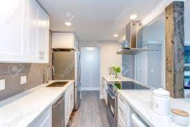 Choose assembled cabinets from 225+. White Small Kitchen With Stainless Steel Appliances In Modern Stock Photo Picture And Royalty Free Image Image 104976996
