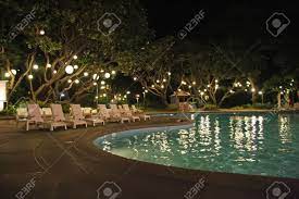 The led underwater pool lights as well can change the colors of the pool and give it different moods at thirdly, having pool lights are great for parties. Swimming Pool Night Time Shot With Hanging Lights On Trees Stock Photo Picture And Royalty Free Image Image 2048767