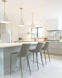 Since kitchens require a higher level of brightness than most other rooms of a home, you may need a few more lights or brighter lights. White Kitchen Ceramic Pendant Lighting Ceramic Lights White Lights Bright White White Modern Kitchen White Kitchen Lighting Kitchen Island Lighting Pendant
