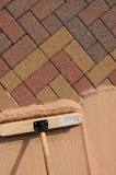 Why do you put sand on block paving?