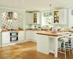 Dark shaker kitchen with white worktops and brass hardware. Kitchens Rustic Kitchen White Shaker Kitchen Howdens Kitchens