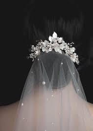 Many brides opt to include a sparkly hair comb, fresh flowers, or other decorative accessory at the top of the veil for added wow factor. Flying High Wedding Veils Above Or Below The Bun