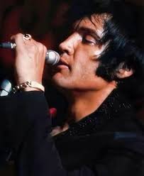 Elvis commanding the stage, every gesture a note, every glance a melody