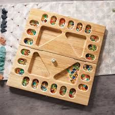 The game is played on a board. Deluxe Four Player Mancala Best For Ages 6 To 12