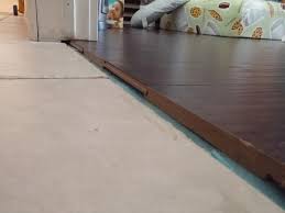 Ceramic tile to laminate floor transition. How To Transition Laminate To Tile If Tile Floor Has A Sag Ceramic Tile Advice Forums John Bridge Ceramic Tile