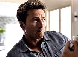 looking at pictures of val kilmer — GLEN POWELL as Ben in ANYONE BUT YOU  (2023)