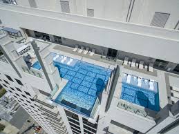 Most people could agree that 10 feet per story is reasonably common. This Clear Bottomed Swimming Pool Hangs 40 Stories Above The Street Conde Nast Traveler Glass Bottom Pool Sky Pool Swimming Pools