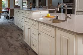 The lighter toned granite is contrasted by dark cabinetry as well as modern chairs. Kitchen Remodel Multi Level Island The Cleary Company