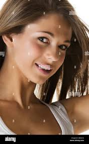 Studio head shot of attractive teen/young adult wearing a white vest top  Stock Photo