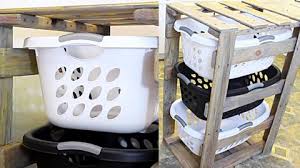 So i built her this diy tilt out laundry hamper storage cabinet and i'm sharing the plans with you! Diy Pallet 3 Tier Laundry Basket Holder