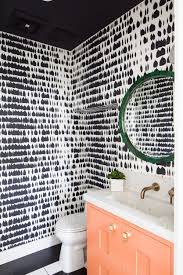 Black And White Powder Room Wallpaper Graphic Black And White Wallpaper In The Powder Bath Coral Painted Vanity Round Mirror Over The Vanit Powder Room Wallpaper Stylish Bathroom Painted Vanity