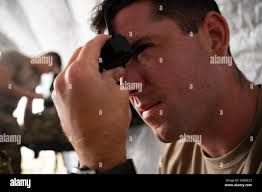 A Special Tactics Airman with the 23rd Special Tactics Squadron looks  through binoculars at Tyndall Air Force Base, Florida, Oct. 14, 2018.  Special Tactics Teams can assess, open, and control major airfields