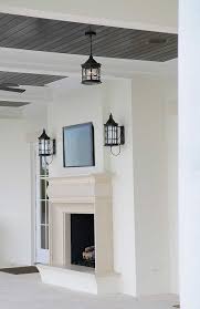 Chic Covered Patio Features A Black Beadboard Ceiling Over A Limestone Composite Fireplace And Hearth Under A Flats Beadboard Ceiling Beadboard Patio Fireplace