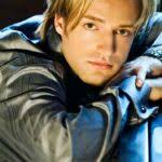 Solo Artist Aaron Shea Sitting At A Piano