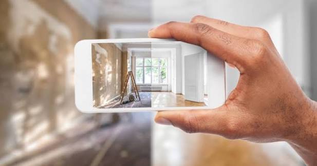 Technician documenting cabling setup via camera