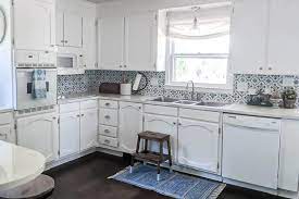 A stain is a thin liquid that seeps into the surface of the wood, permeating the top layer and altering the color. Painting Oak Cabinets White An Amazing Transformation Lovely Etc