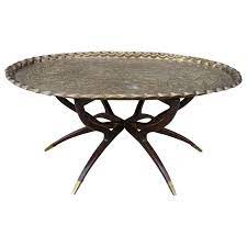 Bates iron burnt brass this drum coffee table features an inverted mushroom shape and has a bit lighter than antique brass. Large Vintage Brass Tray Coffee Table On Midcentury Folding Base At 1stdibs