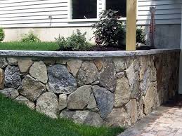 The concrete foundation needed to support a cement block wall is usually created by pouring concrete into a hollow form lining the sides of the excavation trench, but the concrete can also simply be poured into the trench—a common scenario for construction of a freestanding landscape wall. Cinder Block Retaining Wall Stone Facade Hardscape Design Stone Veneer Wall Stone Retaining Wall