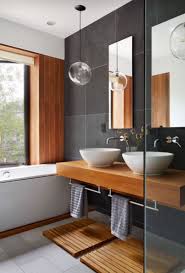 Although surrounded by contemporary decor, a round mirror covered with reclaimed twigs pulls the entire organic look together. Florida Tile Aventis 12x24 And 24x24 Modern Bath Bathroom Newlook Cleanlook Tile Porcelain Contemporary Bathroom Designs Modern Bathroom Bathroom Design