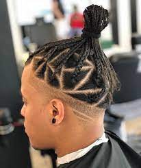 A braid is made on one this extraordinary combination of taper fade haircut with braid and bun gives a fashionable and cool look to gentlemen, as shown in the image below. Man Bun With Tapered Sides Novocom Top