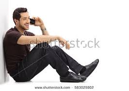Sit with your back against the. Young Man Talking On A Phone While Sitting On The Floor And Leaning Against A Wall Isolated On White Sitting Pose Reference Pose Reference Photo Pose Reference