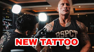 Long live the reign of his new one. The Rock Swag Dwayne Johnson Gets A New Tattoo Done On His Big Muscular Arms Check Out The Design Iwmbuzz