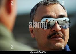 U.S. Airman Staff Sgt. Brian Wirt, assigned to the 325th Civil Engineer  Squadron takes pictures of a drone with an explosive device while wearing  the EOD-8 Bomb suit during Raven's Challenge 2018