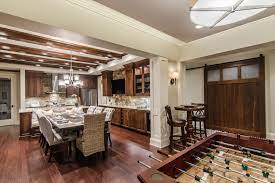 The basement often becomes the main supplier of storage space in a home, and thus requires find clever basement storage ideas here to streamline your overflow of books, electronics, laundry, toys. Finished Basement Kitchen Large Dining Table Acm Design Architecture Interiors