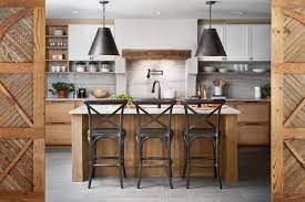 The raw wood vent hood warmed up the space and the clear glass pendant lights over the island brought a modern feel to the kitchen.. Kitchen Design Tips From La Pequena Colina Joanna Gaines